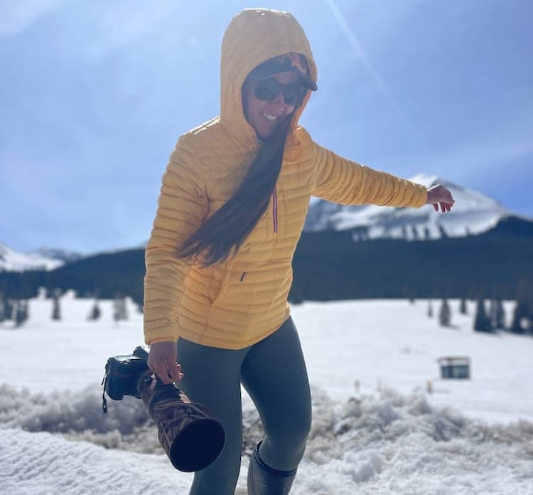 stio pinion down pullover on a hiker in the very snowy mountains with a dramatic alpine scene