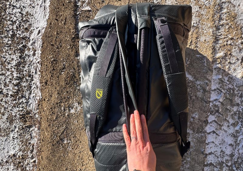 showing off the versatile straps of the Double Haul 100 Liter Convertible Duffel & Tote By NEMO Equipment