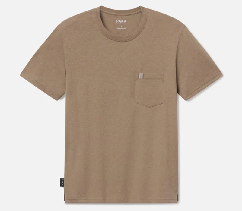Flat lay of the Paka Pocket Tee in cappaccino color, showing its clean design and subtle chest pocket detail.