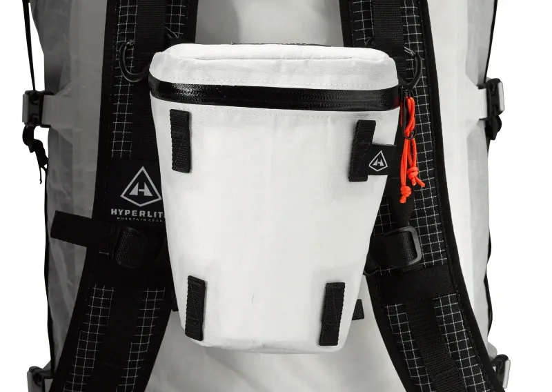 Hyperlite Mountain Gear Camera Pod securely mounted to a white ultralight backpacking pack