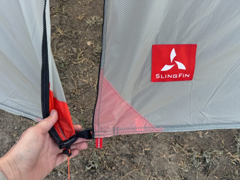  Close-up of SlingFin Cinder Cone zipper system and logo patch showing high-quality materials and construction.