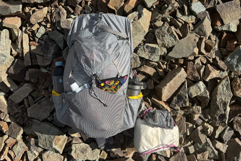  Top-down view of Aarn Mountain Magic 50 Pro backpack fully packed on rocky alpine ground