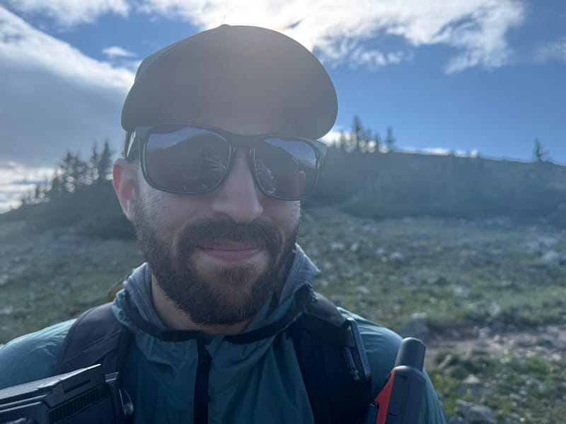 Man wearing FKT Gear Beaten Path Sunglasses with non polarized lenses while hiking in the mountains.