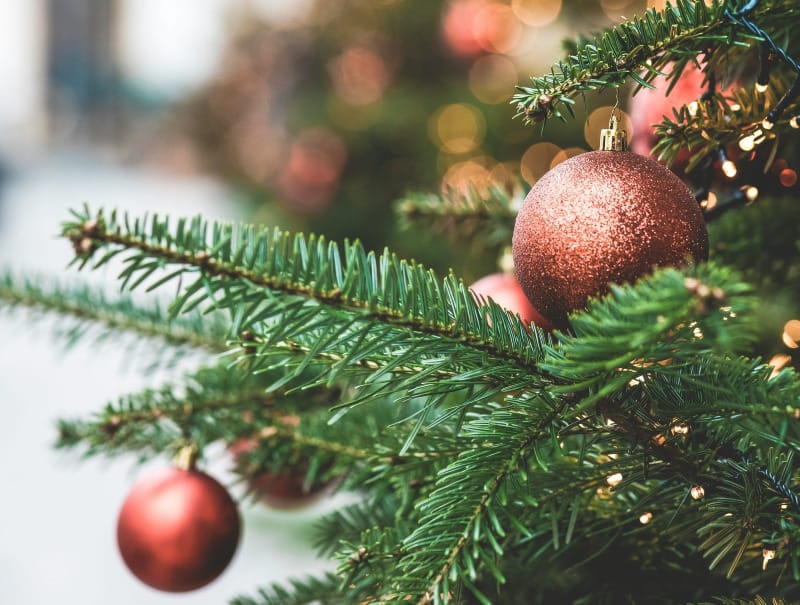 Christmas tree with red ornaments used as festive backdrop for Amazon holiday gifts 2025.