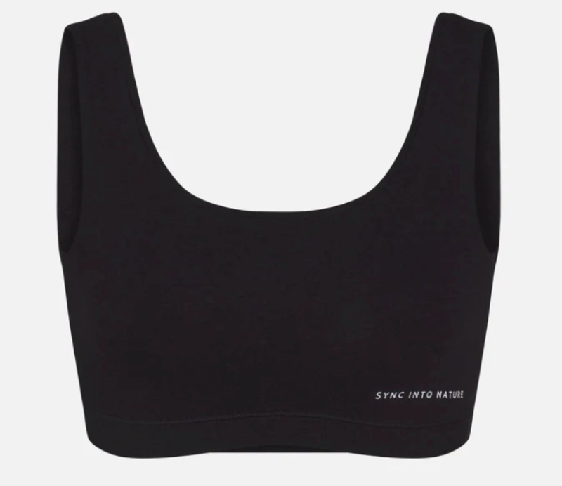 Black merino wool sports bra for hiking and backpacking, offering breathable warmth and odor resistance in cold conditions.