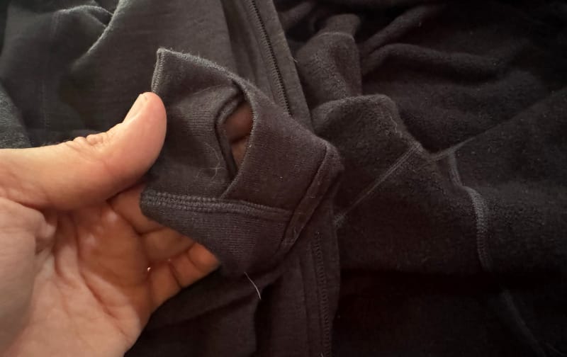 Thumb hole detail on Ibex Mammoth Full-Zip Hoodie sleeve, showing durable stitching and fabric texture.