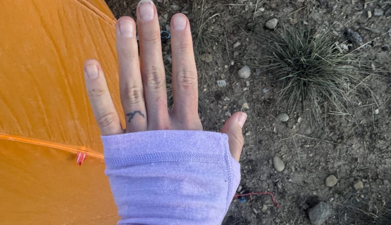 Close-up of the sleeve and thumbhole design on the Ibex Woolies Pro Tech base layer, highlighting stitching and flexible merino fabric texture.