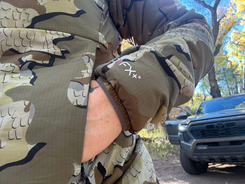 Detail photo of the KUIU Kenai Hooded Jacket sleeve showing 3DeFX+ insulation and camouflage fabric pattern.