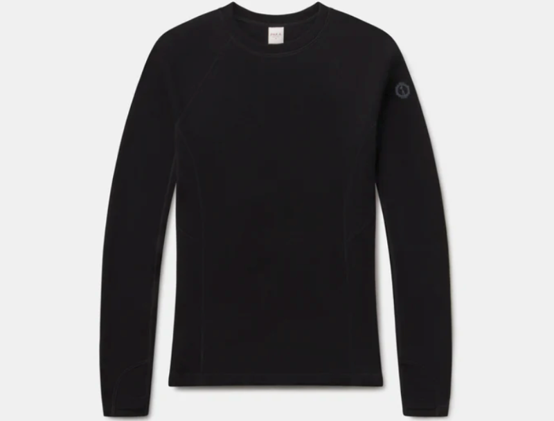 Flat lay image of black PAKA Thermal Crew base layer on a white background, showing long sleeves and sleek construction.