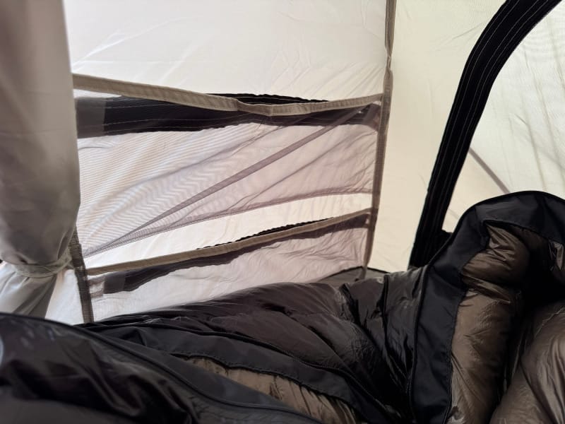 Interior view of Snow Peak Minute Dome Pro Air 1 tent showing mesh door and sleeping bag setup.