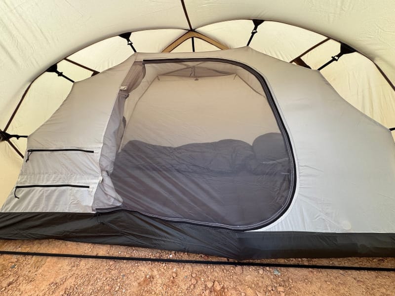 Snow Peak Minute Dome Pro Air 1 vestibule with outer fly open showing ample gear space and desert landscape beyond.