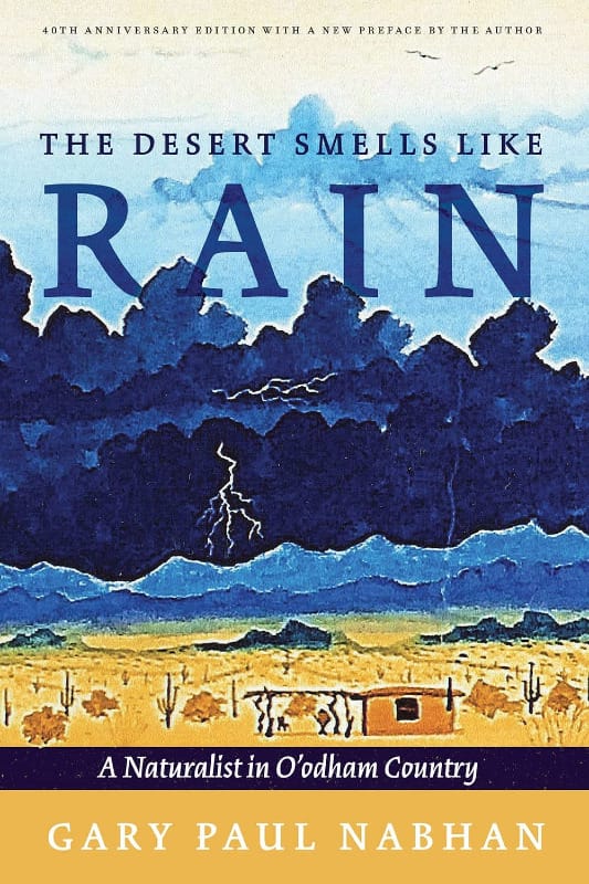 Cover of The Desert Smells Like Rain by Gary Paul Nabhan, showing a desert landscape under storm clouds with lightning.