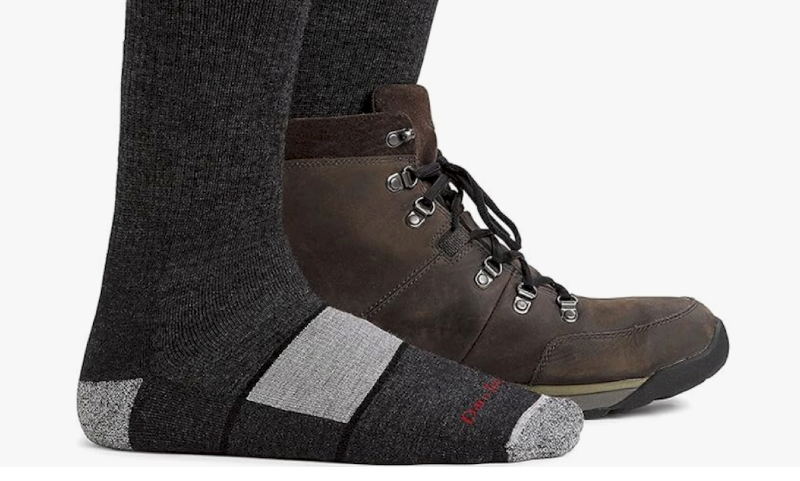 Close-up of Darn Tough merino wool hiking socks worn with brown hiking boots.
