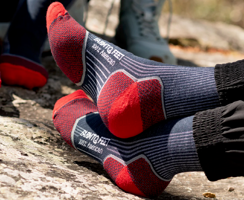 Close-up of Farm To Feet merino wool hiking socks with red heels and toes, made in the USA.