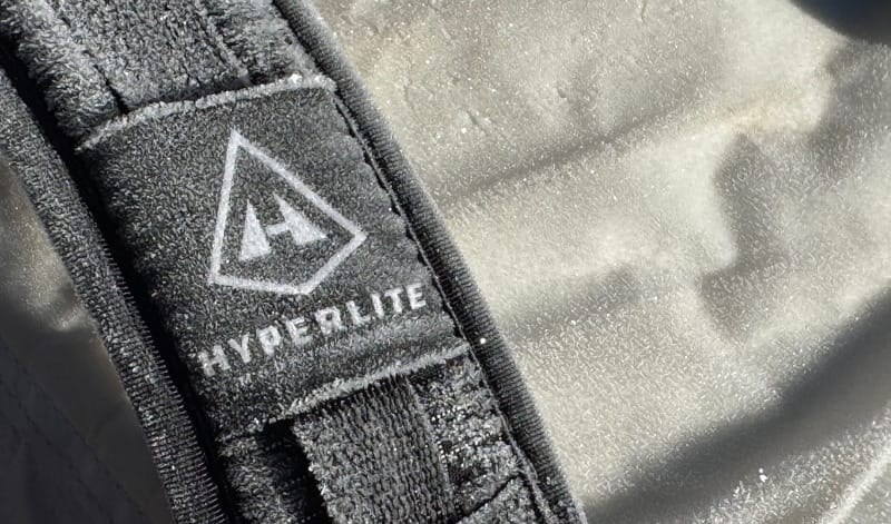 Close-up of the shoulder strap on a Hyperlite Mountain Gear Southwest backpack with frost and sunlight highlighting the pack’s Dyneema fabric.
