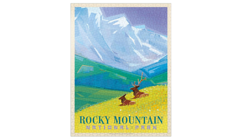 Jigsaw puzzle featuring an illustrated Rocky Mountain National Park scene with elk in a meadow and tall snowy peaks.