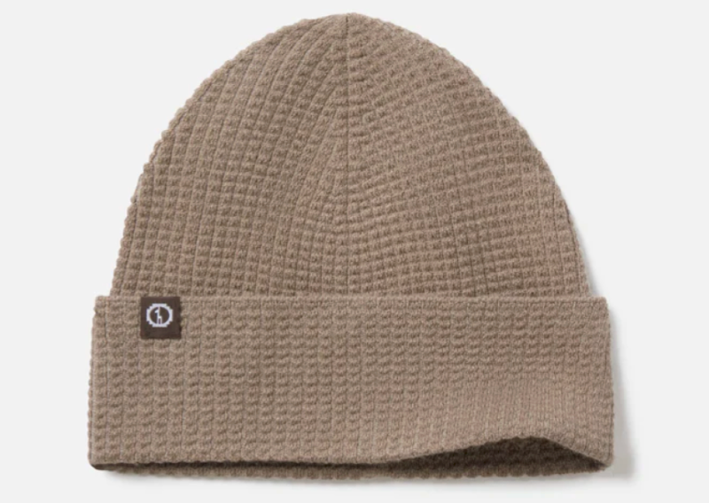 Tan PAKA waffle knit beanie made from merino wool, folded cuff design.