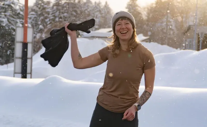 Hiker wearing Woolly Clothing’s 100% merino wool fleece jacket during winter adventure, promoting the 2025 Holiday Sale with sitewide discounts and free tee offer.