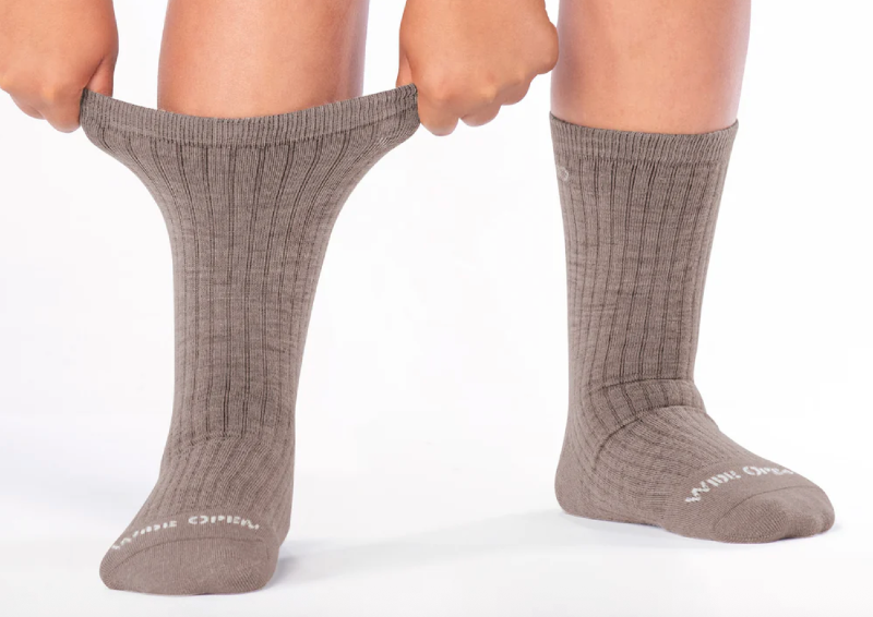Wide Open Socks cushioned micro crew hiking socks made with a wool blend, featuring a stretchy, non-binding cuff and comfortable fit for hikers with larger calves in 2026.