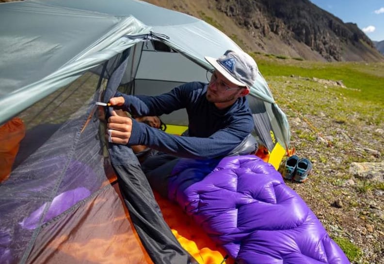 Interior of an ultralight solo backpacking tent with sleeping bag and pad, showing space and comfort for one person