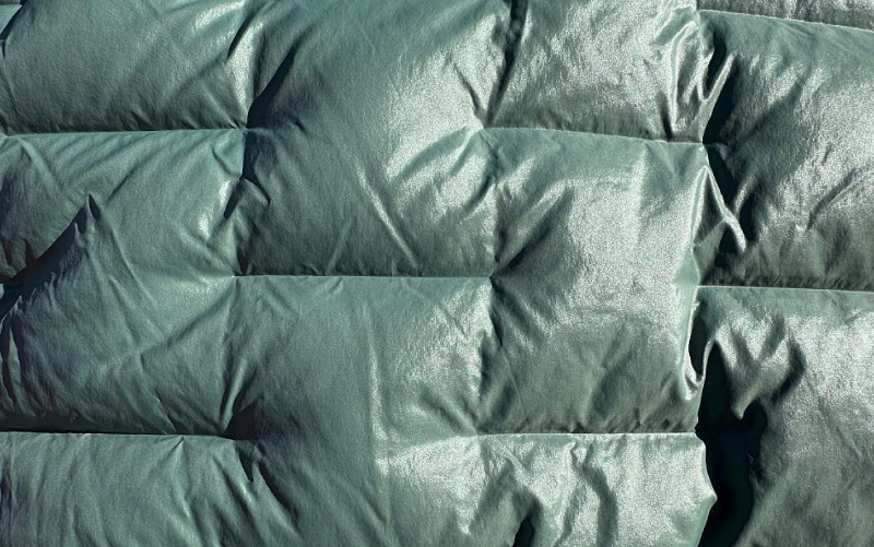 Close-up detail of the Outdoor Vitals NovaPro Down Jacket baffle construction and lightweight fabric texture