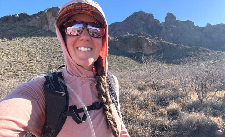 a woman wears the The Aspen Ultralight Backpack By Symbiosis Gear on a backpacking trip in the southwest
