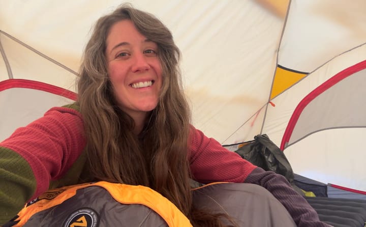  Close-up selfie of a hiker wearing a SAMBOB Microgrid Hoodie with the hood up in a dry, forested backcountry setting.