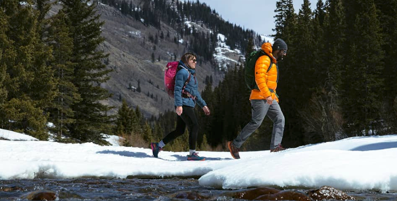Hiker wearing an Osprey backpack on a winter trail, promoting the Osprey Winter Sale 2025 with up to 40% off select packs and free shipping through December 1.