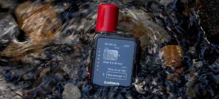 Garmin inReach Mini 3 Plus satellite communicator resting in a flowing stream, demonstrating its durable, water-resistant design for hiking and backpacking in remote terrain.